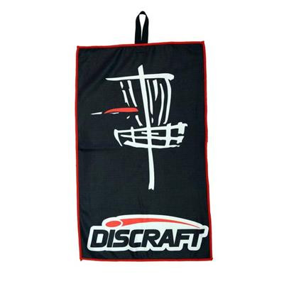 Discraft DISC GOLF TOWEL - BASKET Design - shows black vertical-rectangle towel with a red border and a graphic of a white hand-drawn-style disc golf basket and a red disc hitting the chains from the left. Discraft logo appears at the bottom.
